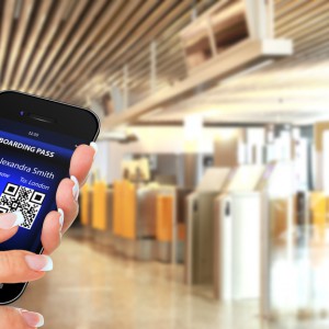 hand holding mobile phone with mobile boarding pass