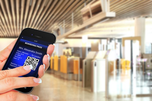 hand holding mobile phone with mobile boarding pass
