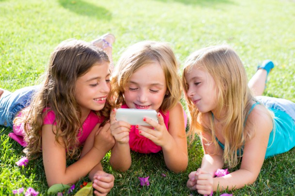 children friend girls playing internet with smartphone