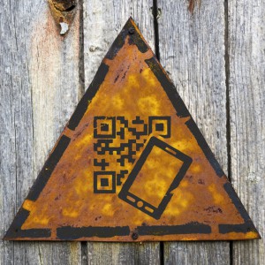 QR Code Icon on Weathered Warning Sign.