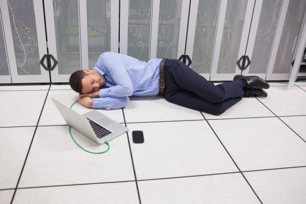 Man sleeping in data center on the floor