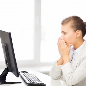stressed student with computer in office