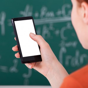 College Student Using Smart Phone In Classroom