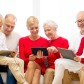 smiling family with tablet pc computers at home