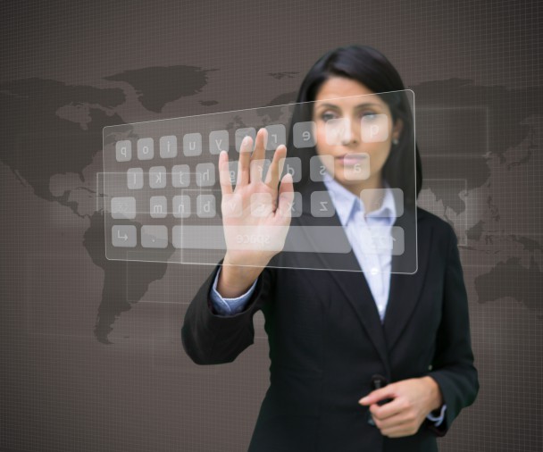 Businesswoman touching projected digital keyboard on brown world map