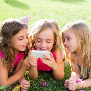 children friend girls playing internet with smartphone