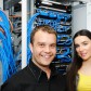 Two administrators, male and female, at server room