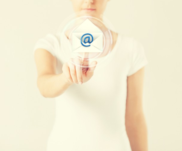 woman pressing virtual button with e-mail icon