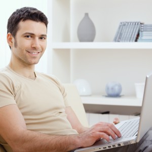 Happy man using computer