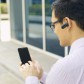 Businessman Calling On Mobile Phone With Bluetooth Handsfree