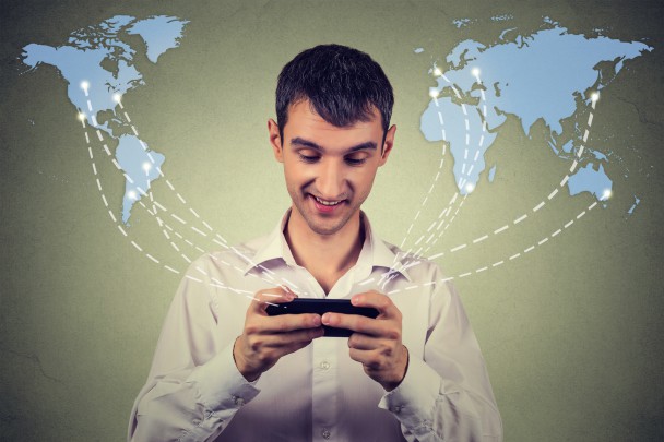 business man holding smartphone connected browsing internet worldwide