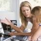 Woman and young girl in home office with computer looking unhapp