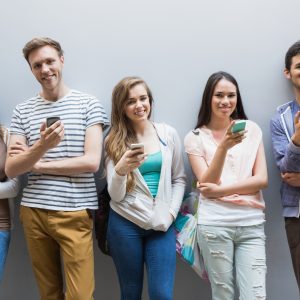 Students using their smartphones in a row at the university